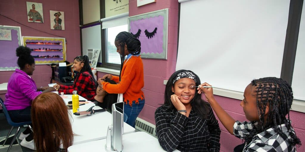Toledo Prep students practicing makeup and hairstyling in the cosmetology classroom
