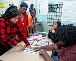 Toledo Prep students collaborating around a classroom table