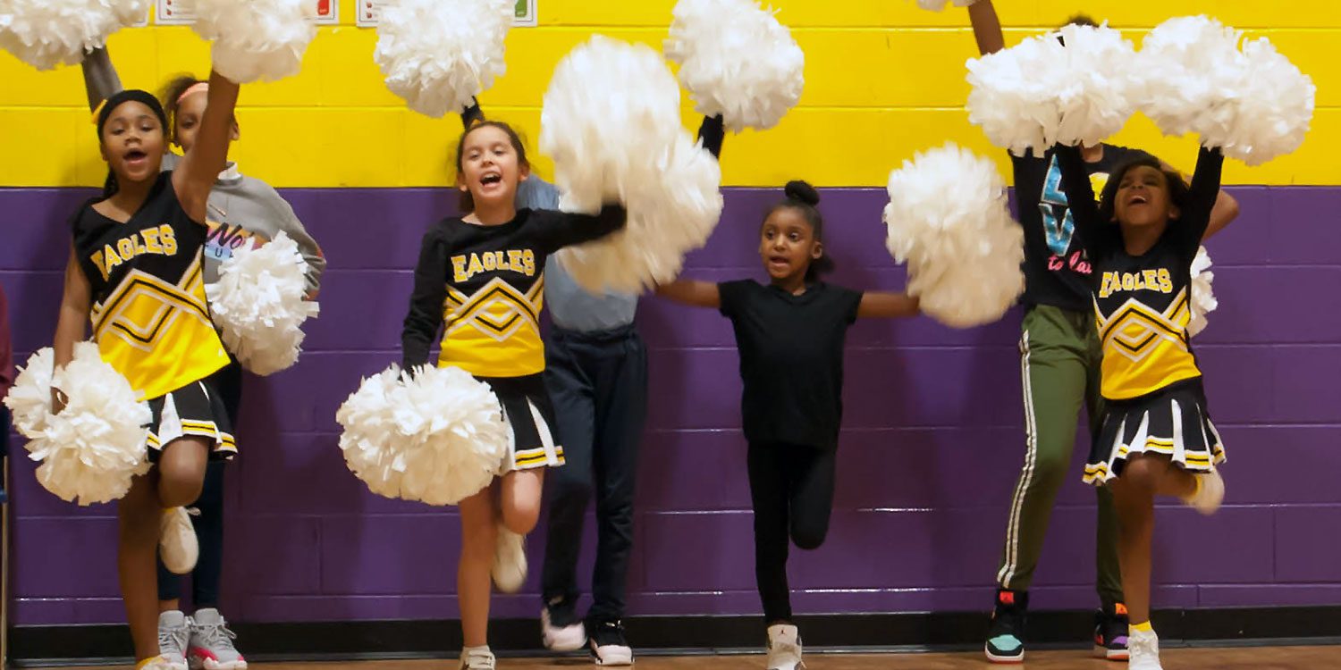 Elementary cheerleaders in gym.