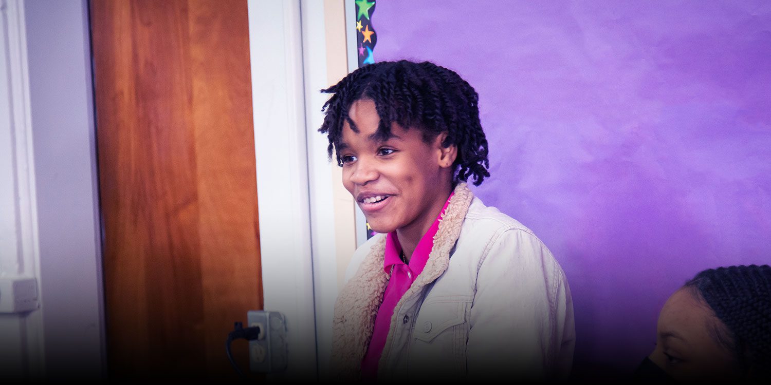 Smiling student in a classroom.